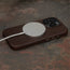 MagSafe charger attached to the Dark Brown Slimline Leather Bumper Case for iPhone 15 Pro