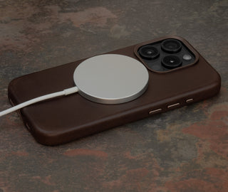 MagSafe charger attached to the Dark Brown Slimline Leather Bumper Case for iPhone 15 Pro
