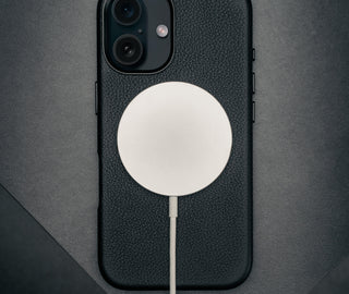 MagSafe charger connected to the Black Leather Slimline Bumper Case for iPhone 16