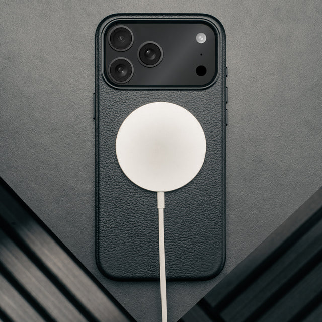 MagSafe charger attached to the Slimline Black Leather Bumper Case for iPhone 17 Pro