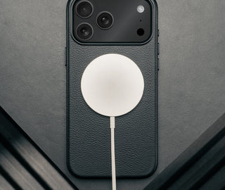 MagSafe charger attached to the Slimline Black Leather Bumper Case for iPhone 17 Pro