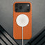 MagSafe charger attached to the Slimline Orange Leather Bumper Case for iPhone 17 Pro Max