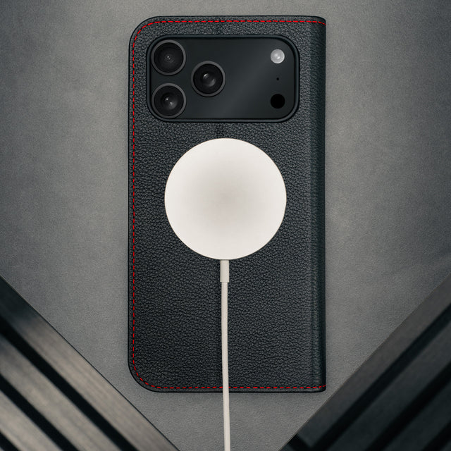 MagSafe charger attached to the Black Leather Case (with Red Stitching) for iPhone 17 Pro Max