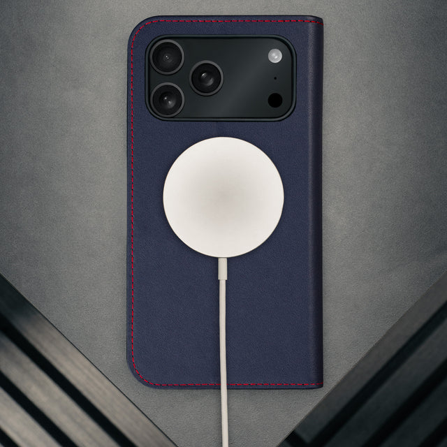 MagSafe charger attached to the Navy Blue Leather Case (with Red Stitching) for iPhone 17 Pro Max