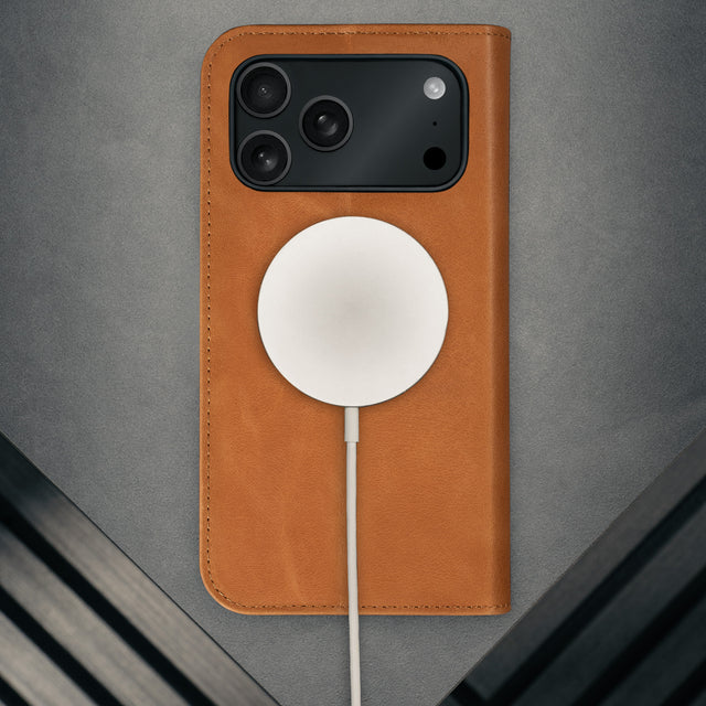 MagSafe charger attached to the Tan Leather Case for iPhone 17 Pro