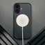MagSafe charger attached to the Black Leather Bumper Case for iPhone 17