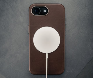 MagSafe charger attached to the Dark Brown Slimline Leather Bumper Case for iPhone SE4 (2025)