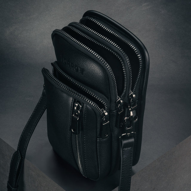 Three open zipped compartments of the Black Leather Phone Bag