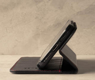 Demonstrating the stand function of the Black Leather (with Red Stitching) Stand Case for iPhone XR