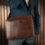 Man carrying the Dark Brown Leather Messenger Bag