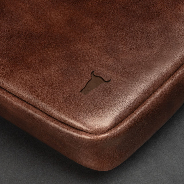 Dark Brown Leather Messenger Bag on a wooden table