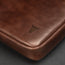 Dark Brown Leather Messenger Bag on a wooden table