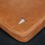 Tan Leather Messenger Bag on a wooden table