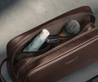 Toiletry items in the Dark Brown Leather Wash Bag